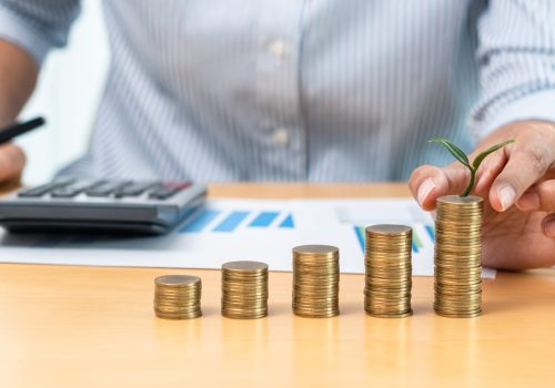 asian-business-woman-putting-to-stacking-coins-wit-2025-10-15-04-57-16-utc