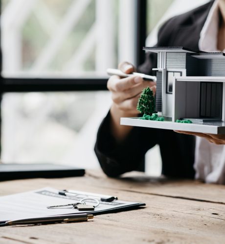 Rental company employee is discussing the details before the customer agrees to sign a rental contract, explaining the details and the terms and conditions of the rental. Real estate rental ideas.